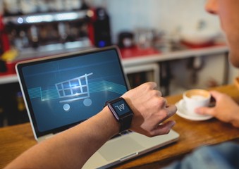 Poster - Man using Laptop with Shopping trolley icon