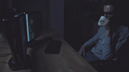 Concentrated tired programmer working at night