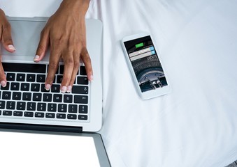 Poster - phone with log in screen and laptop with hands on the bed