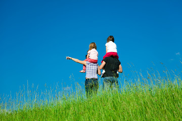 Family Standing At The Top Of A Hill