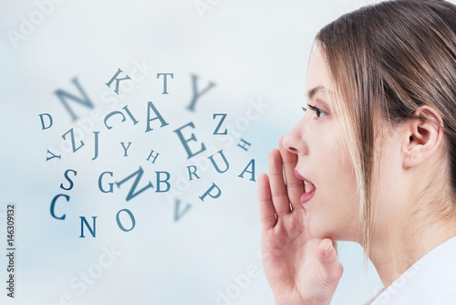 Fotografía Woman talking with alphabet letters coming out of her mouth