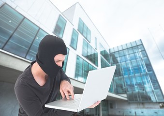 Poster - Criminal Man in balaclava on laptop in front of glass building