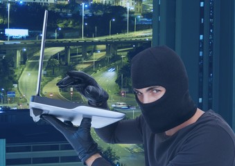Poster - Criminal Man in hood in front of city lights