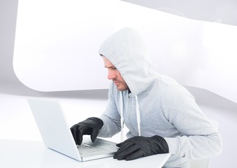 Poster - Criminal Man in hood on laptop in front of modern background