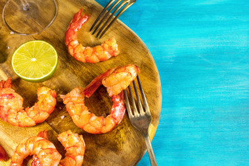 Cooked shrimps with two forks and copyspace