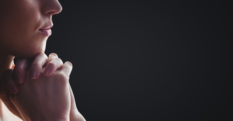 Poster - woman praying against dark grey background
