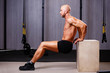 © Vadym - Young healthy bald ripped man with big muscles pushing up in gym