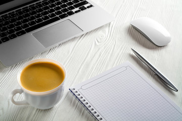Poster - Start of Morning work office desk with a cup of coffee computer laptop, notebook, pen,  White wood texture table. Business concept background