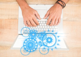 Poster - Overhead of hands on laptop with blue cog graphics