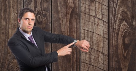 Poster - Confident businessman showing time on wristwatch