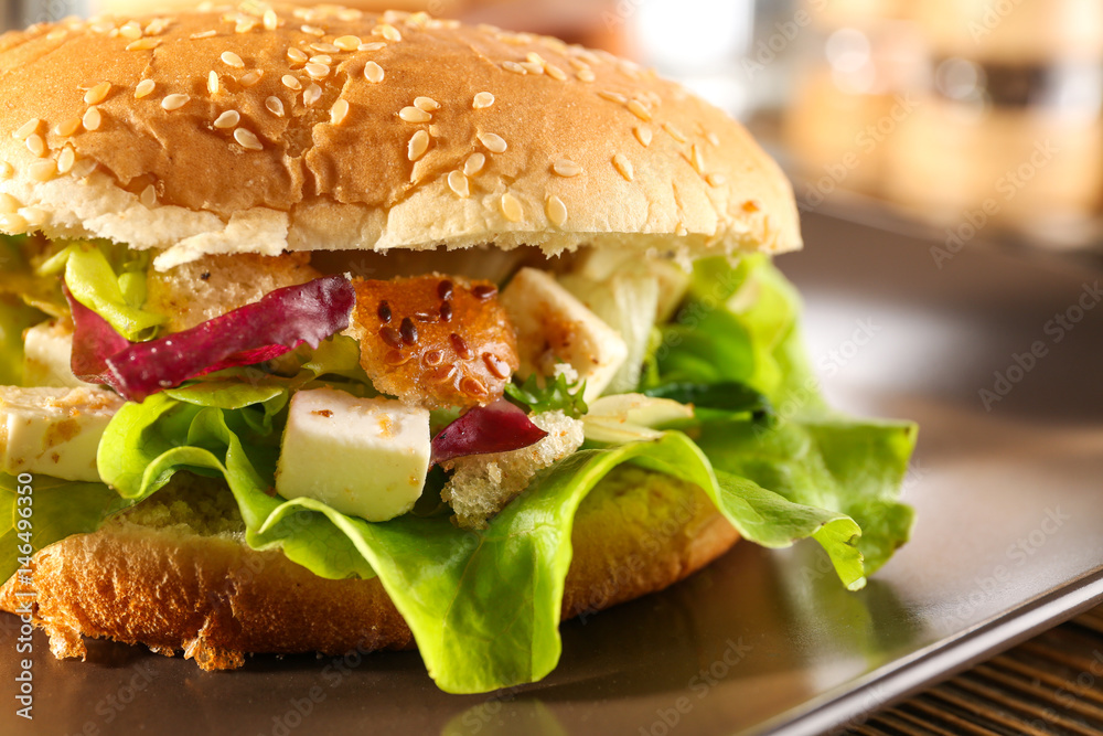 Plate with chicken salad in burger bun, closeup