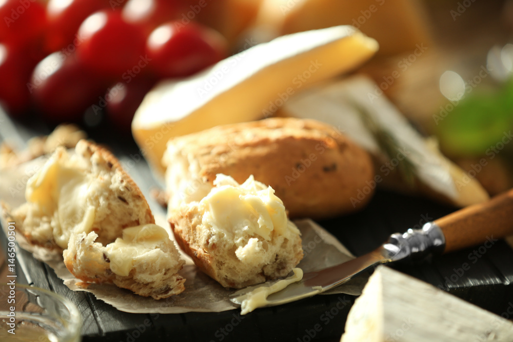 Bread pieces with cheese on wooden board, closeup