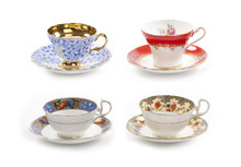 High Resolution Close-up Of Four Beautiful Antique Tea Cups With Saucers Isolated On A White Background.
