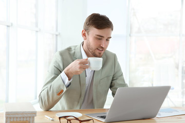 Sticker - Handsome young man working with laptop in office