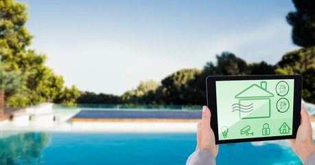 Poster - Cropped image of person using smart home app on tablet PC at poo