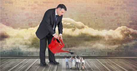 Wall Mural - Digital composite image of businessman pouring 