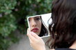 © Andre Ila - Beautiful young woman looking into a mirror at herself