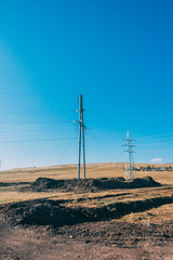 electric power transmission pylon on inner mongolia grassland against blue sky ,china.