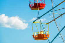 Colorful Cabins Of Ferris Wheel On Blue Sky Background