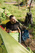 © ninelutsk - Male tourists drinking coffee from mugs in the tent