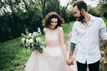 Wall Mural -  Loves and very happy groom and bride in the park