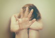 © M-Production - Scared woman sitting in the corner.