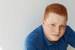 © sementsova321 - A close-up portrait of redhead guy with freckles wearing blue shirt having confident expression isolated over white background with copy space for your text or advertising content