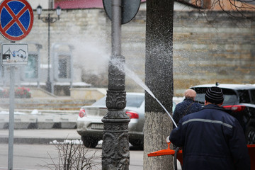 Cleaning the dirty post in the city post with high pressure washer in the spring.