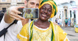 © gustavofrazao - Tourist taking a selfie with a Baiana in the old colonial district of Salvador, Brazil