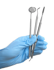 Hand holding dental equipment on white background