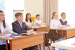 © Africa Studio - Pupils sitting at desk in classroom