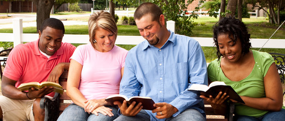 Diverse group of people talking and reading.