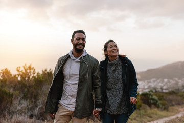 Wall Mural - Happy hikers walking in the countryside