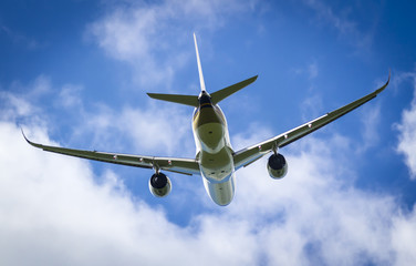 Plane taking off from Manchester Airport into a sunny blue sky