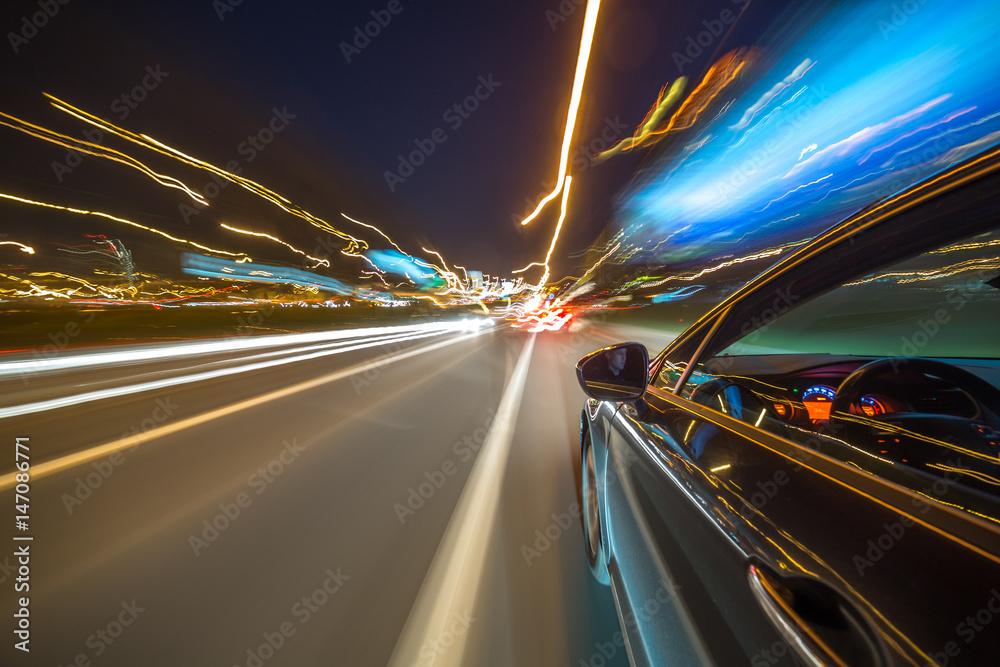 View from Side of Car moving in a night city, Blured road with lights ...