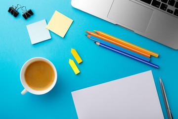 Poster - Start of Morning work office desk with a cup of coffee computer laptop pencil Sheet paper notebook pen blue texture table Business concept background