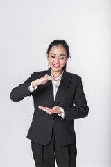 Wall Mural - Attractive young beautiful Asian businesswoman showing empty copy space on her open hand palm