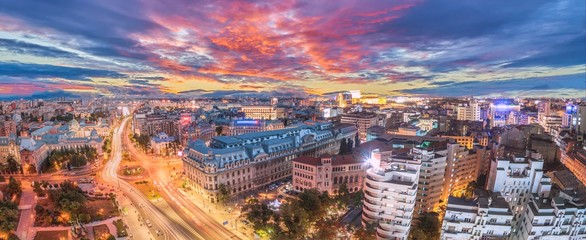 Canvas Print - Panorama of traffic lights in the center of the capital city of Romania. Center of Bucharest at sunset. Romanian Parliament and University square.