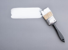 Paint Brush With White Paint Stroke On Grey  Background,top View