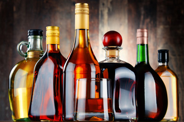 Wall Mural - Glass and bottles of assorted alcoholic beverages