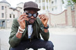 © AS Photo Family - Close up portrait of stylish african american man wear on sunglasses and cap outdoor. Street fashion black man.