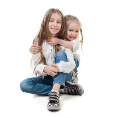 Wall Mural - Two sisters holding each other, isolated