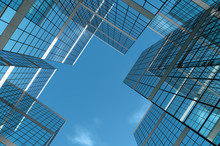 Abstract Group Of Building With Bright And Clear Sky Both On Background And Reflecting On Facade. 3D Illustration.