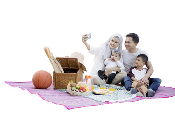 Wall Mural - Family taking selfie photo while picnic