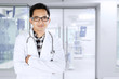 © Creativa Images - Young doctor standing in medical room