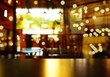 © bidala - top of wood table with blur light bar cafe or pub at night