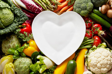 Wall Mural - Heart-shaped plate over vegetables