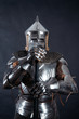 © sky_diez - A medieval warrior in a helmet and with a sword. Knight on dark background