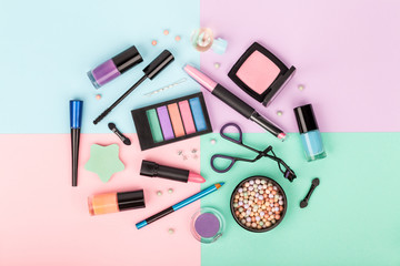 Wall Mural - set of professional decorative cosmetics, makeup tools and accessory on colorful background. beauty and fashion concept. flat lay composition, top view