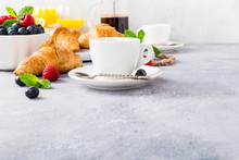 Healthy Breakfast With Coffee, Croissants, Fresh Berries And Orange Juice On Light Gray Background, Selective Focus, Copy Space.